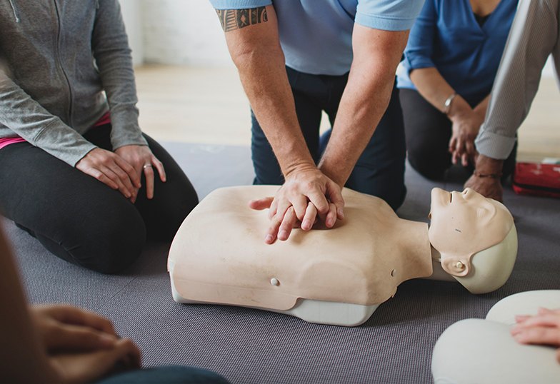 Group CPR training session — compressions on a manikin